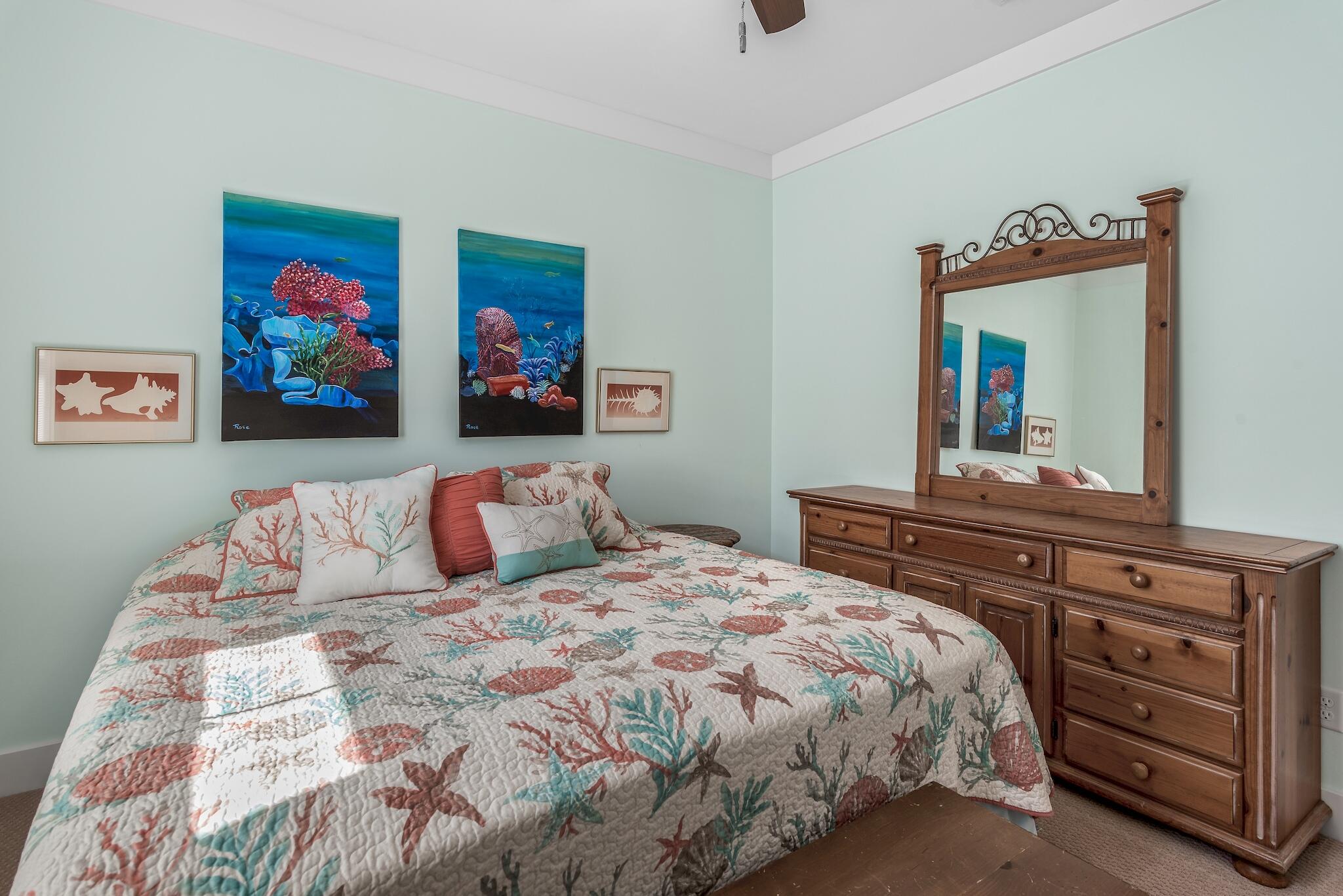 225 Turtle Cove Panama City Beach, FL 32413 - Photo 24 of 43 a bedroom with a bed and a dresser