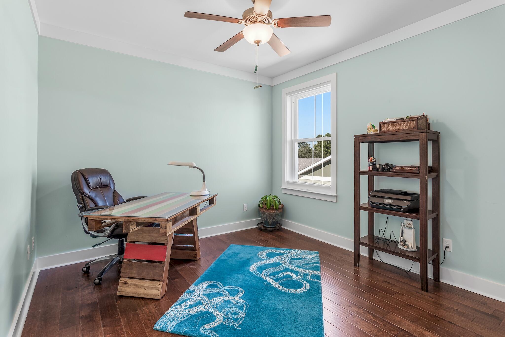 225 Turtle Cove Panama City Beach, FL 32413 - Photo 25 of 43 a living room with furniture and wooden floor
