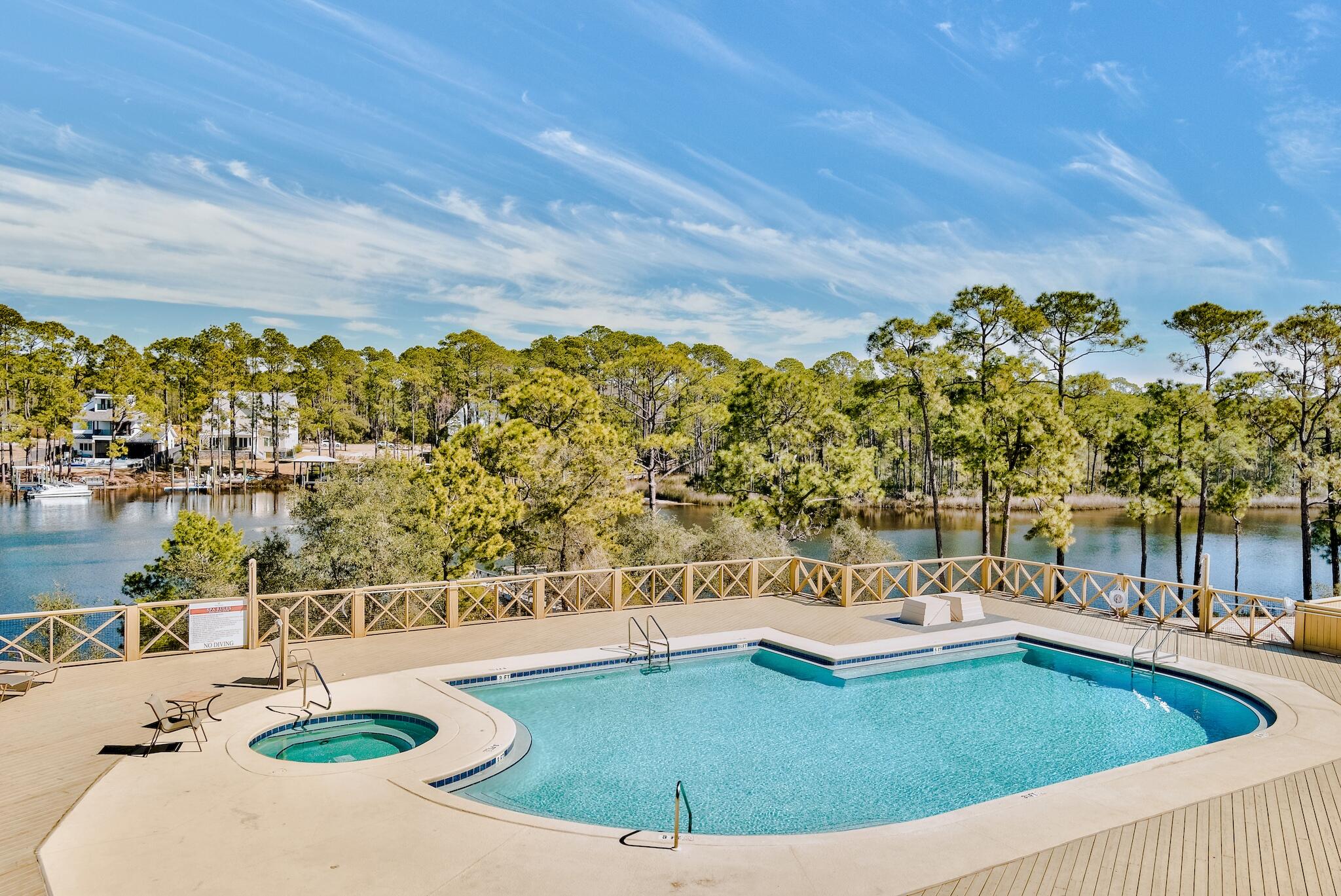 225 Turtle Cove Panama City Beach, FL 32413 - Photo 30 of 43 a view of a swimming pool with a lake view
