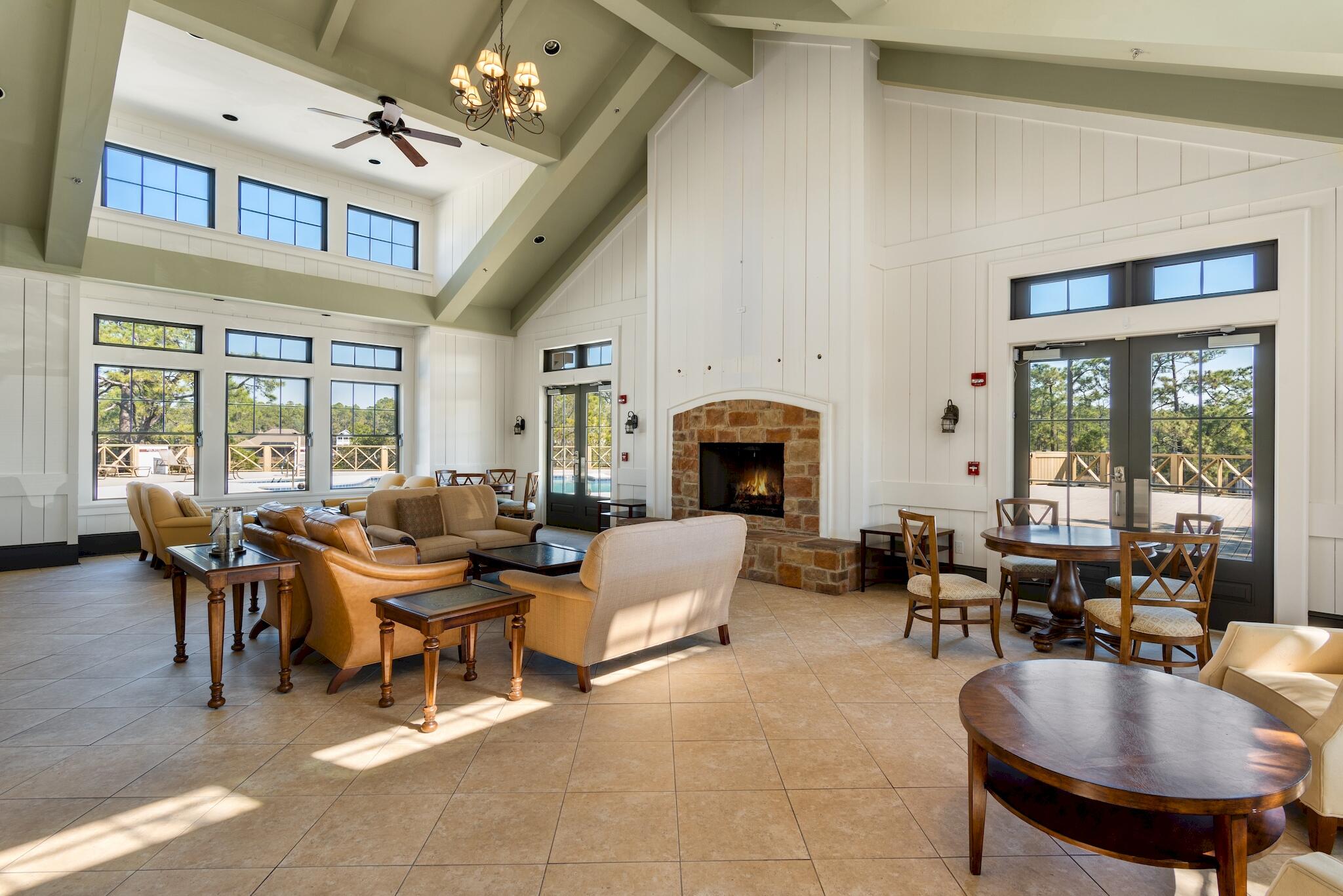 225 Turtle Cove Panama City Beach, FL 32413 - Photo 32 of 43 a living room filled with furniture a fireplace and a large window