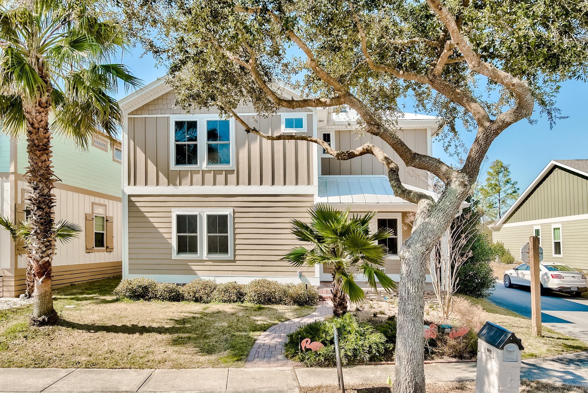 225 Turtle Cove Panama City Beach, FL 32413 - Photo 42 of 43 a front view of a house with a tree