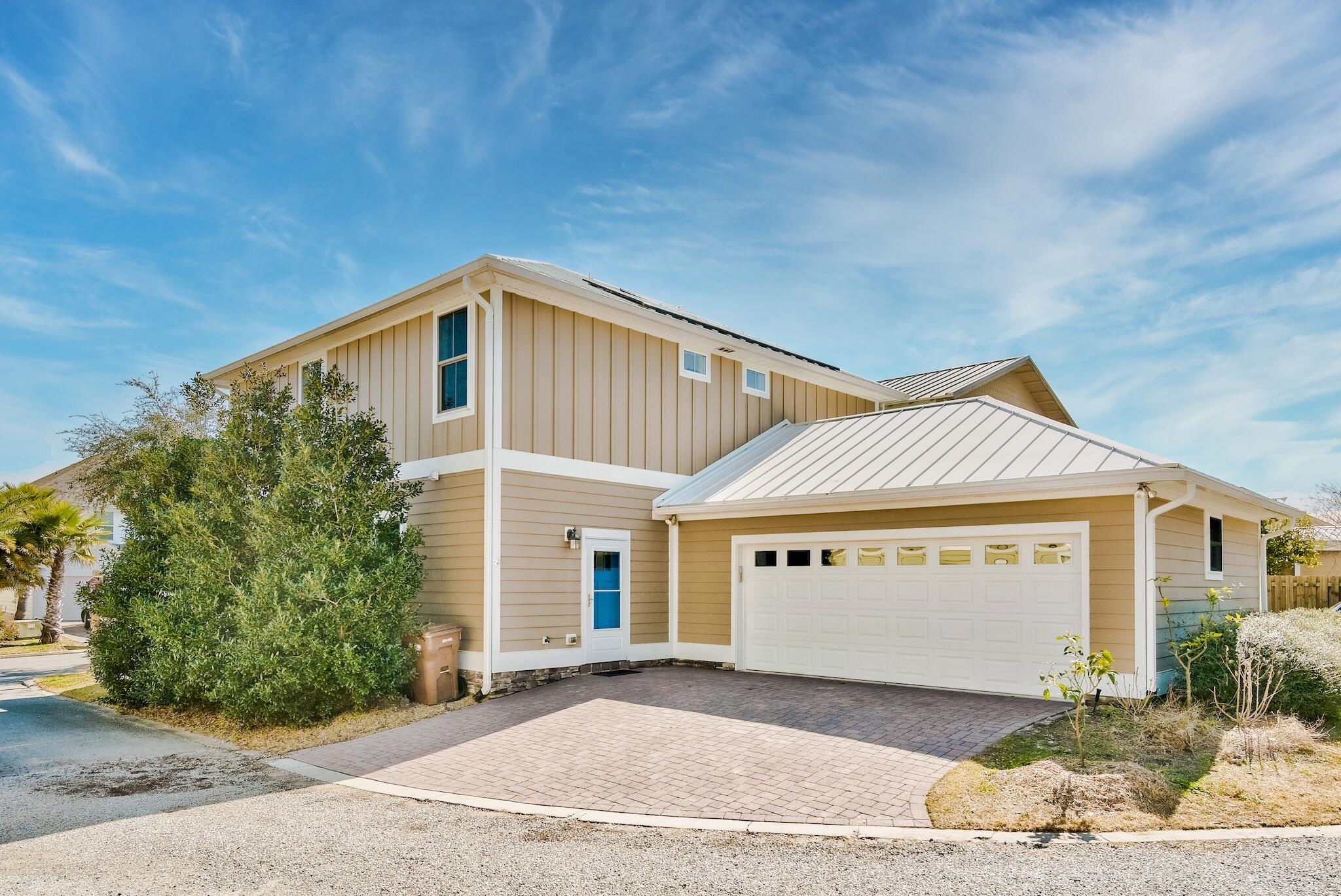 225 Turtle Cove Panama City Beach, FL 32413 - Photo 43 of 43 a front view of a house with a garden and plants