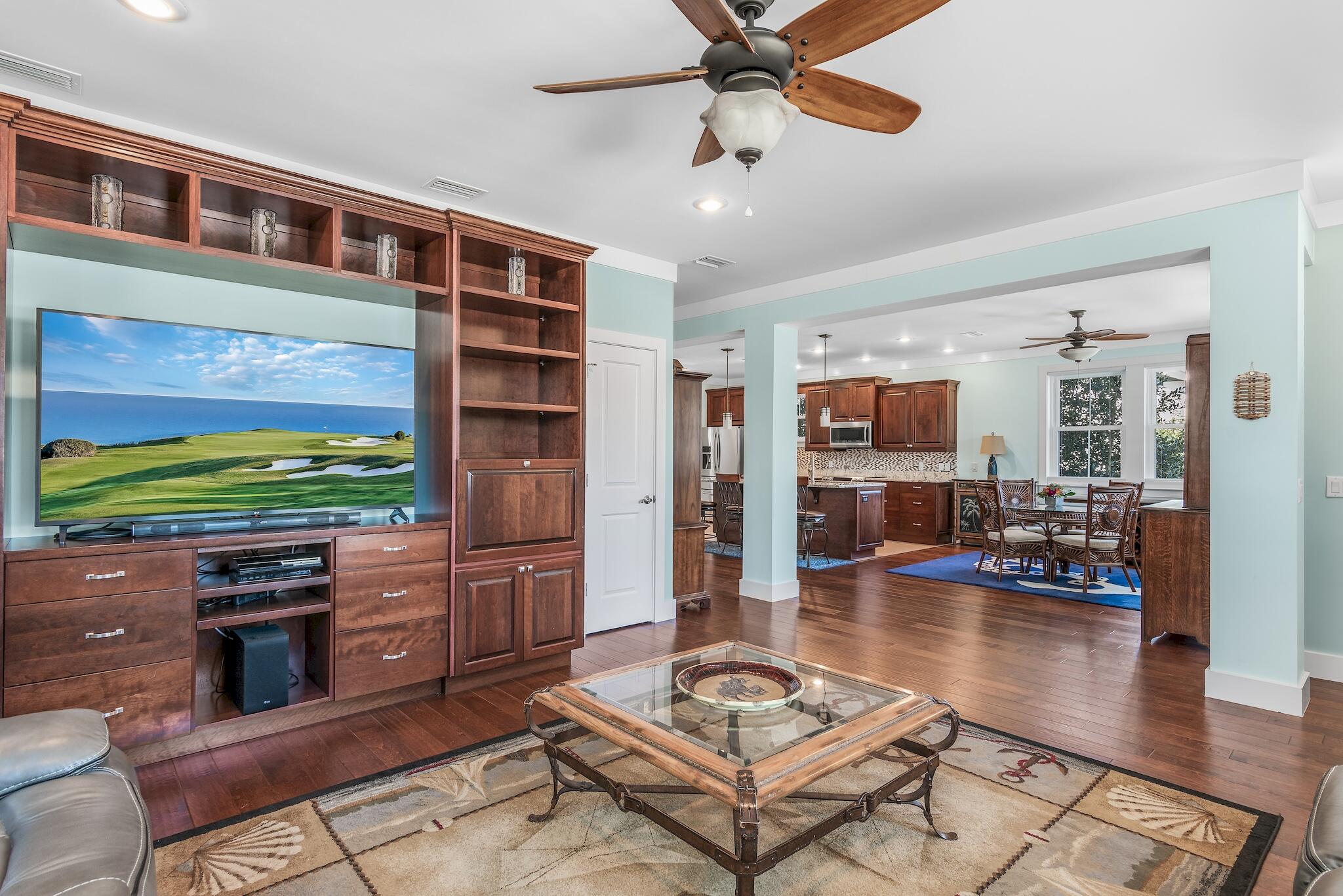 225 Turtle Cove Panama City Beach, FL 32413 - Photo 5 of 43 a living room with furniture a rug and kitchen view