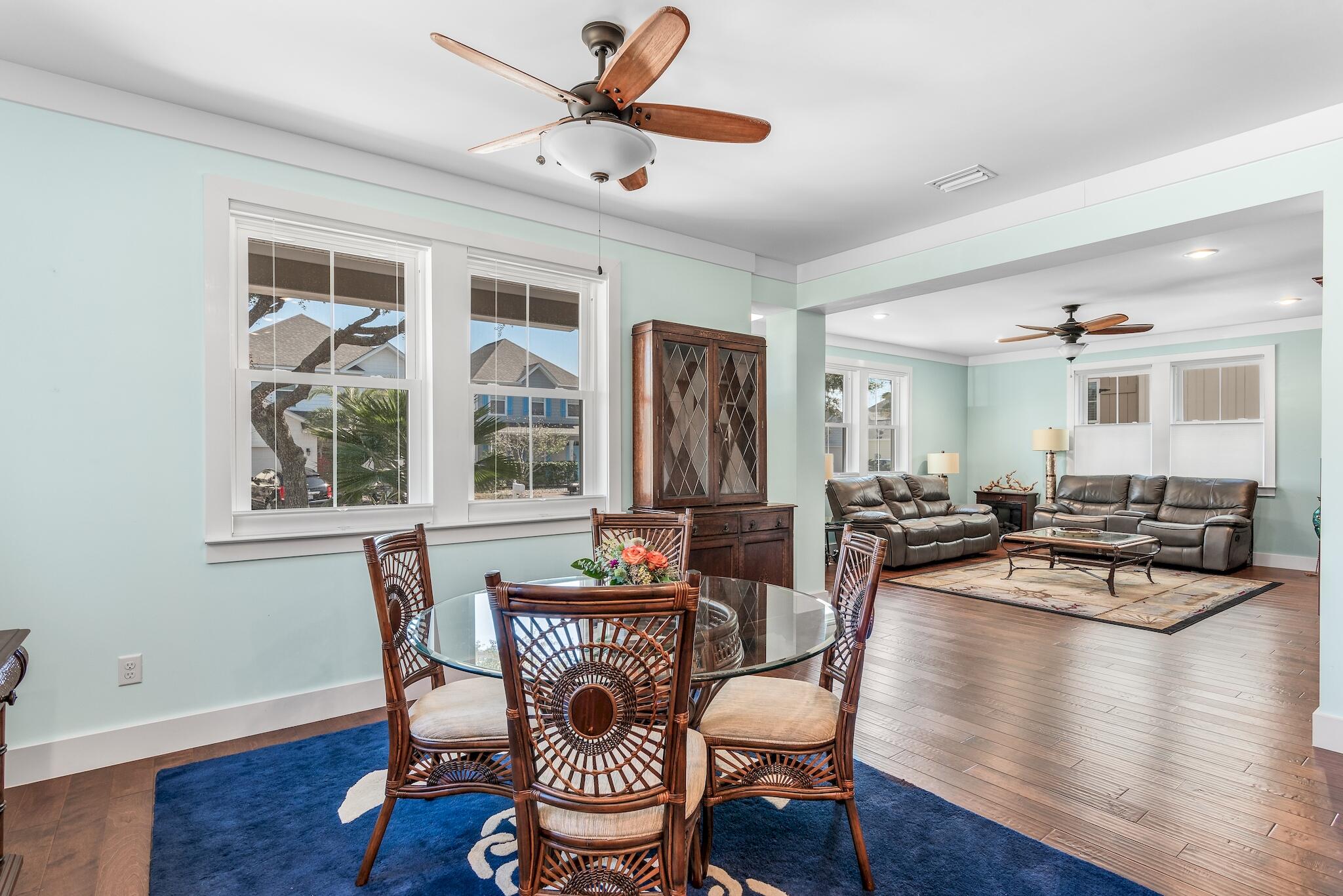 225 Turtle Cove Panama City Beach, FL 32413 - Photo 7 of 43 a dining room with wooden floor and a chandelier