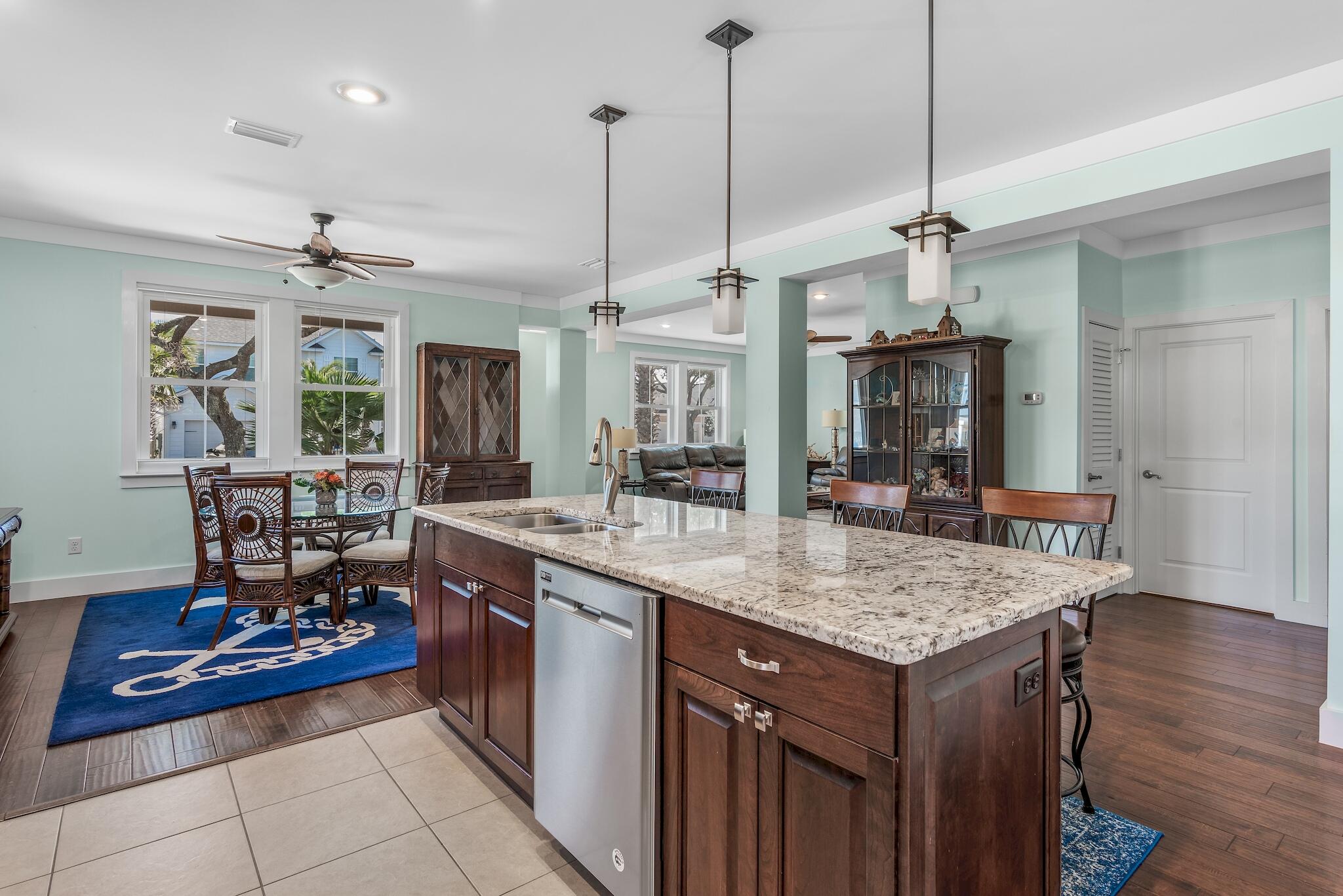 225 Turtle Cove Panama City Beach, FL 32413 - Photo 8 of 43 a kitchen with stainless steel appliances granite countertop a stove a sink dishwasher and a wooden cabinets with wooden floor