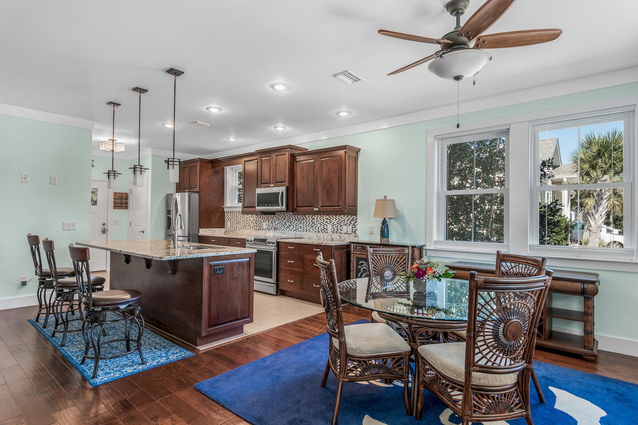 225 Turtle Cove Panama City Beach, FL 32413 - Photo 10 of 43 a large kitchen with a table and chairs