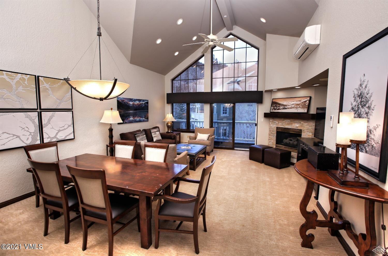 210 Offerson Road, Unit 40850 Beaver Creek, CO 81620 - Photo 3 of 16 a view of a dining room with furniture a chandelier and wooden floor