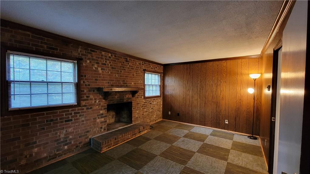 755 Irish Road Rural Hall, NC 27045 - Photo 22 of 32 As you descend to the lower level the additional living room with the wood burning fireplace is directly in font of you.