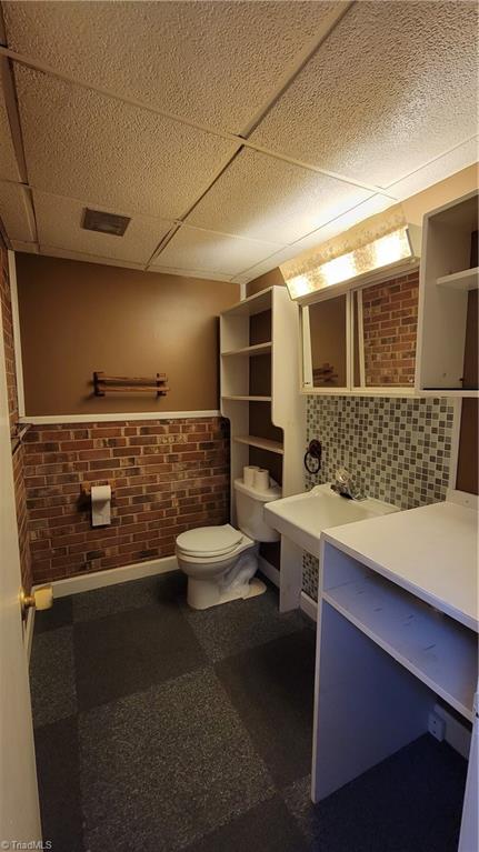 755 Irish Road Rural Hall, NC 27045 - Photo 24 of 32 To the right of the lower level stairs is a hallway with the 1/2 bath and laundry rooms.