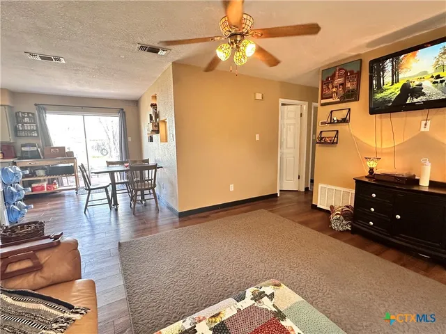 a kitchen with stainless steel appliances a sink a stove and a wooden floor
