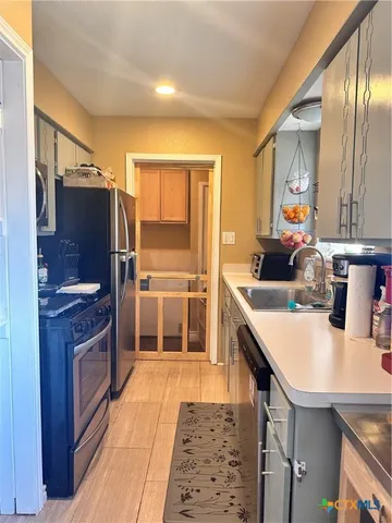 a view of a livingroom with furniture and staircase