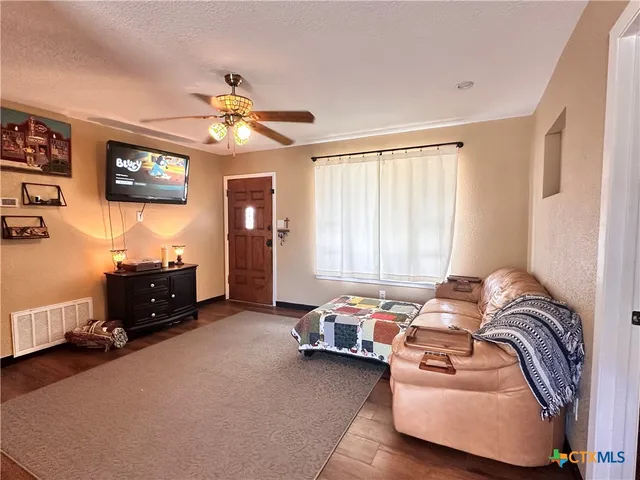 a bedroom with a bed and a ceiling fan