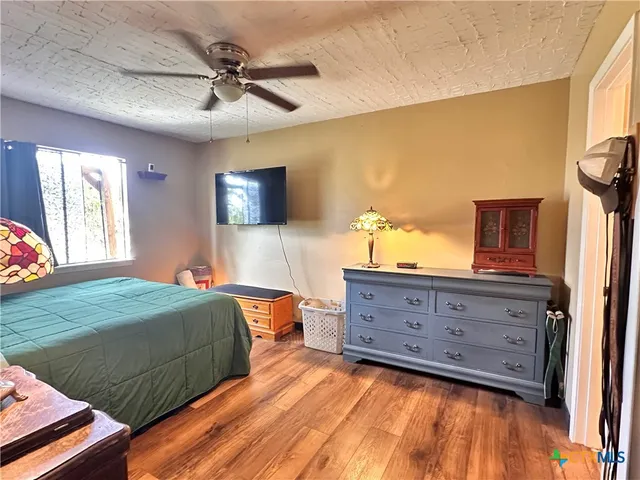 a bedroom with a bed and ceiling fan