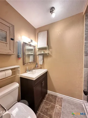 a kitchen with stainless steel appliances granite countertop a sink and a refrigerator