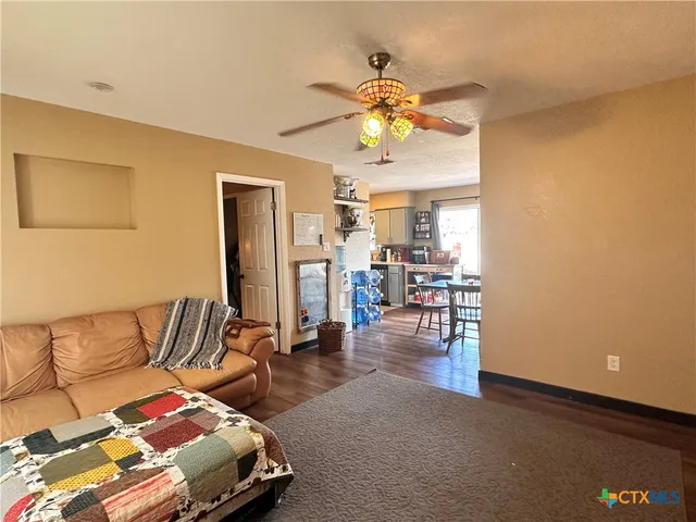 a kitchen with granite countertop a sink appliances and cabinets