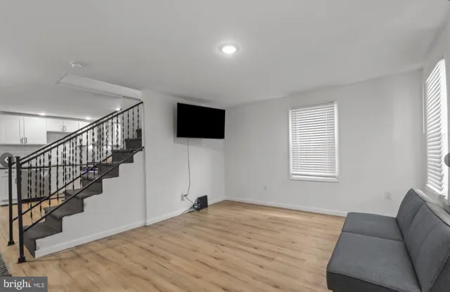 a view of a livingroom with wooden floor and a window
