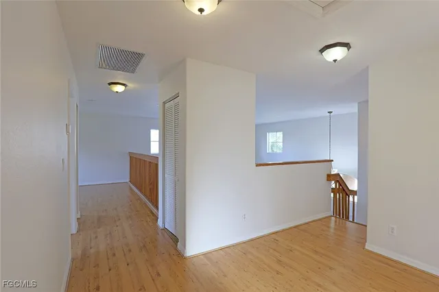 a view of hallway with wooden floor