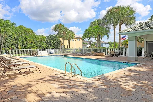 a view of a house with swimming pool and sitting area
