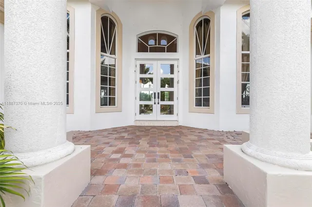 a living room with furniture chandelier and a rug