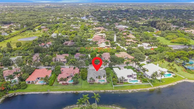 an aerial view of residential houses with outdoor space and swimming pool