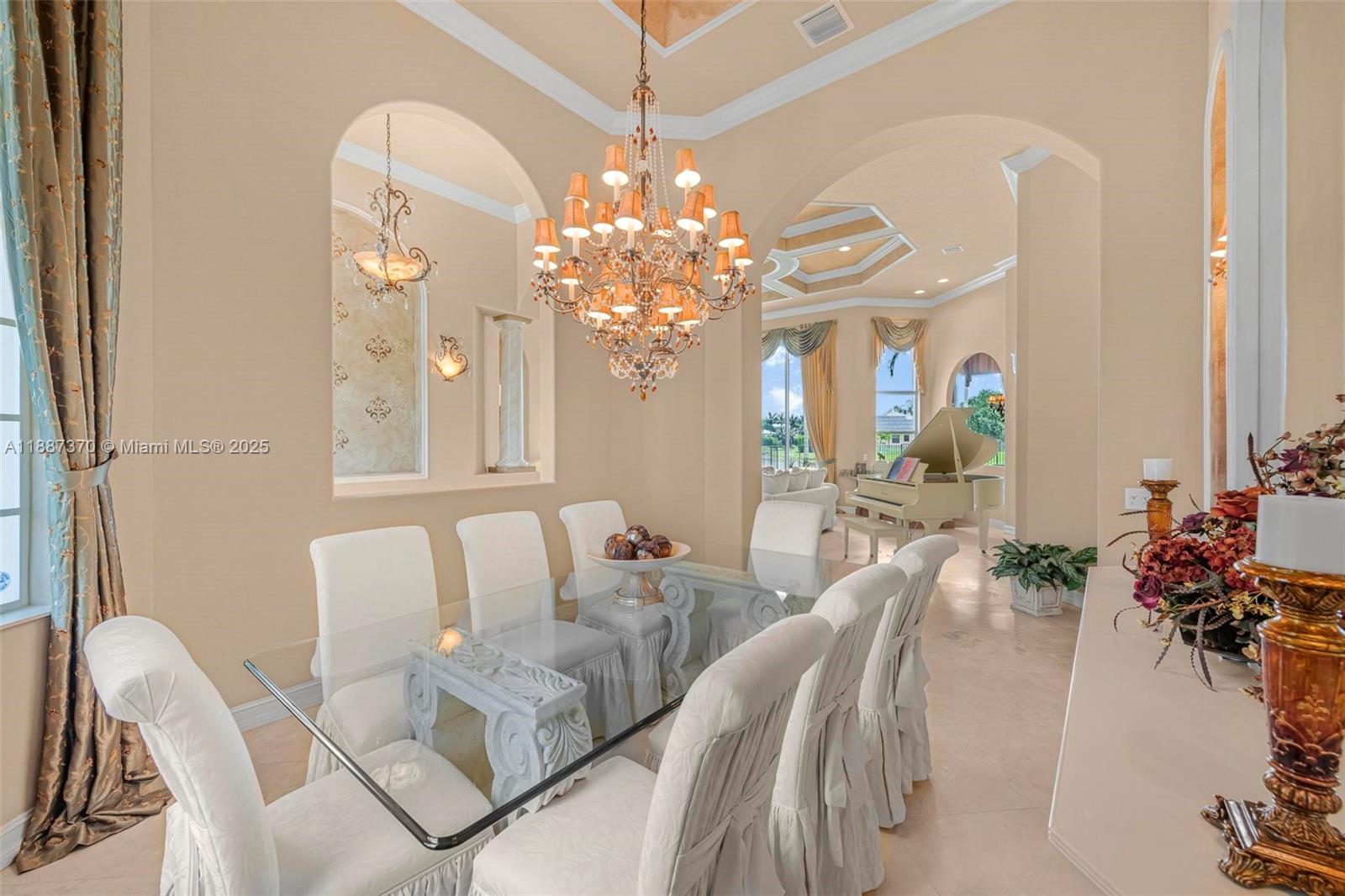 3250 West Stonebrook Circle Davie, FL 33330 - Photo 21 of 73 a view of a dining room with furniture and a chandelier