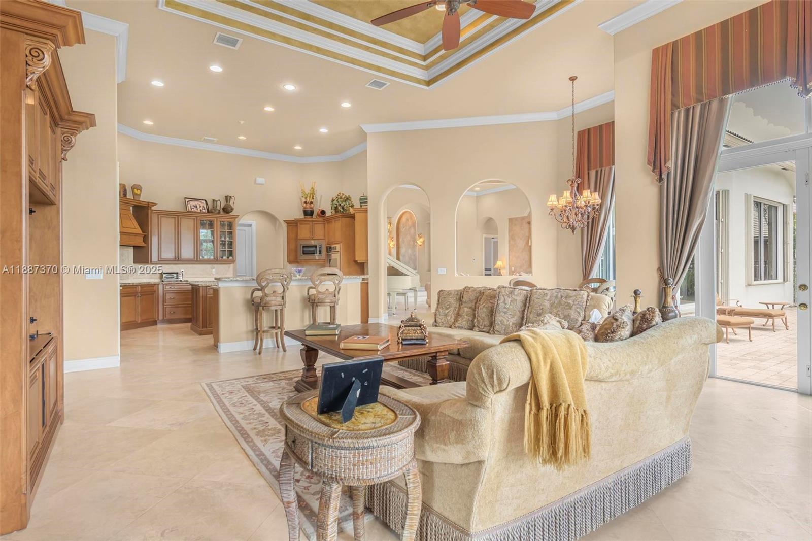 3250 West Stonebrook Circle Davie, FL 33330 - Photo 29 of 73 a living room with fireplace furniture and a table