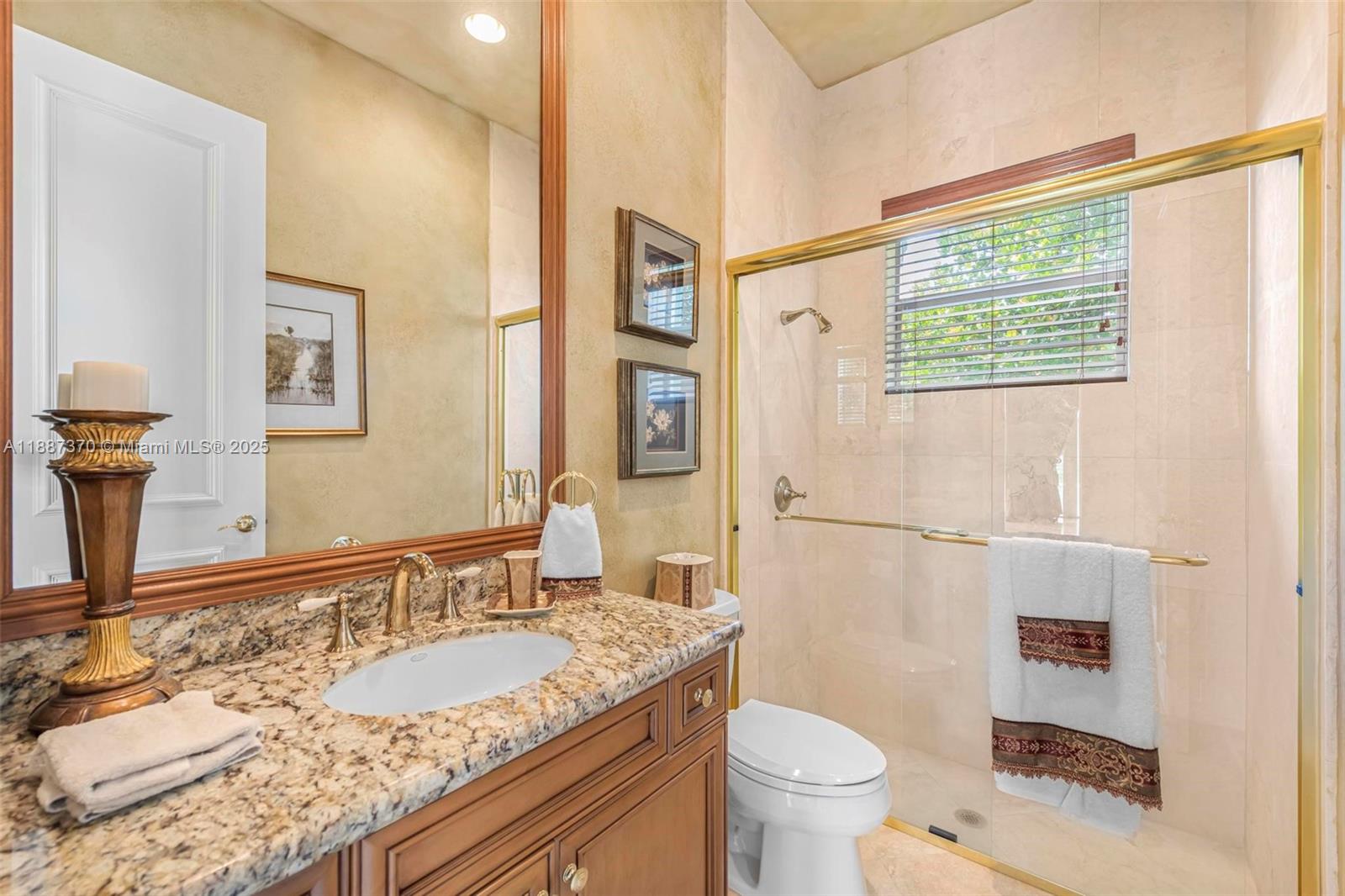 3250 West Stonebrook Circle Davie, FL 33330 - Photo 32 of 73 a bathroom with a granite countertop sink toilet and shower
