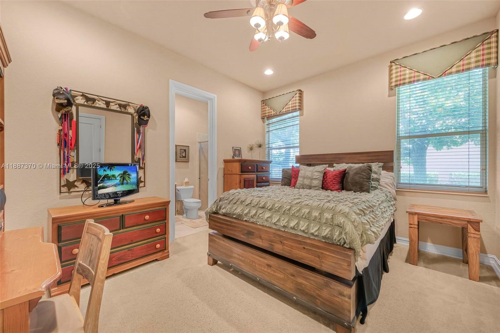 3250 West Stonebrook Circle Davie, FL 33330 - Photo 44 of 73 a bedroom with a bed and a chandelier