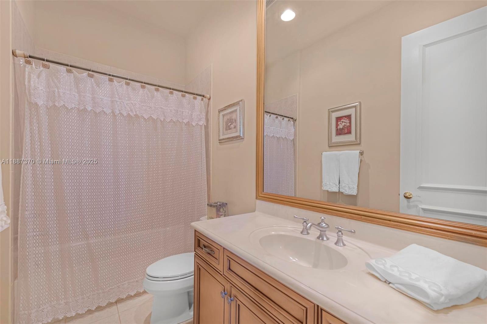 3250 West Stonebrook Circle Davie, FL 33330 - Photo 49 of 73 a bathroom with a sink a toilet and shower curtain