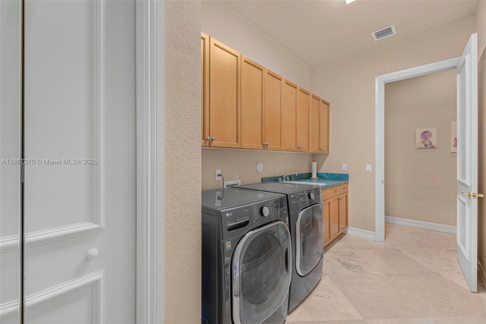 3250 West Stonebrook Circle Davie, FL 33330 - Photo 50 of 73 a utility room with sink dryer and washer