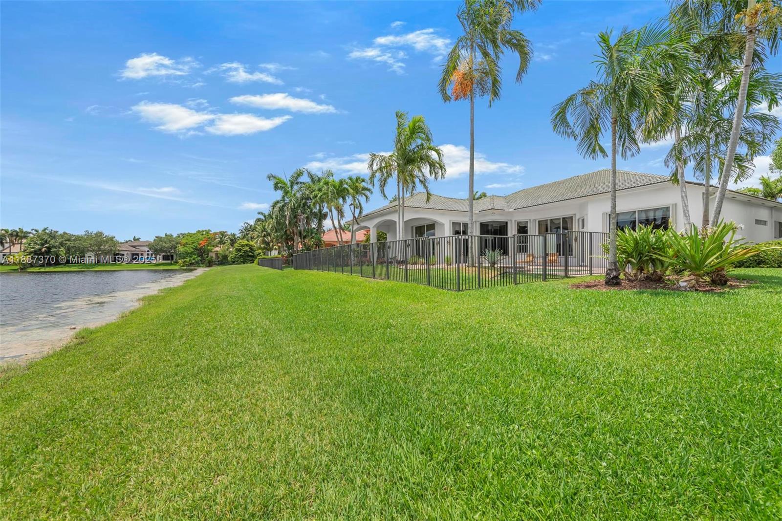 3250 West Stonebrook Circle Davie, FL 33330 - Photo 60 of 73 a view of a house with a big yard and palm trees
