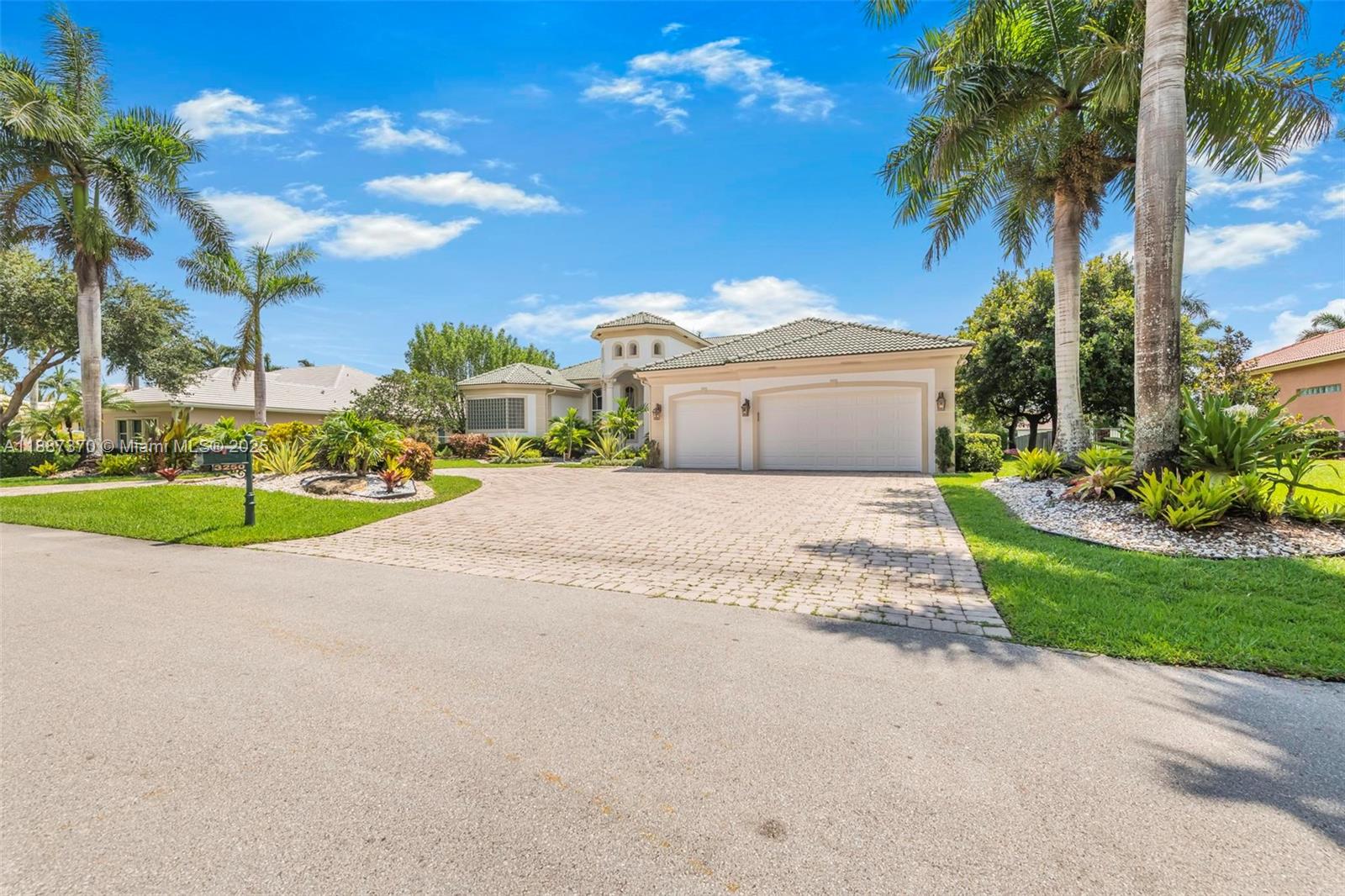 3250 West Stonebrook Circle Davie, FL 33330 - Photo 10 of 73 a view of a house with palm trees and a small yard