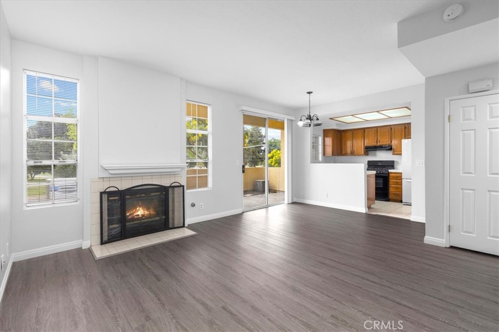 4512 Workman Mill Road, Unit G128 Whittier, CA 90601 - Photo 4 of 26 wooden floor fireplace and windows in an empty room