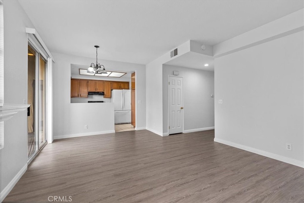 4512 Workman Mill Road, Unit G128 Whittier, CA 90601 - Photo 7 of 26 a view of empty room with wooden floor and kitchen