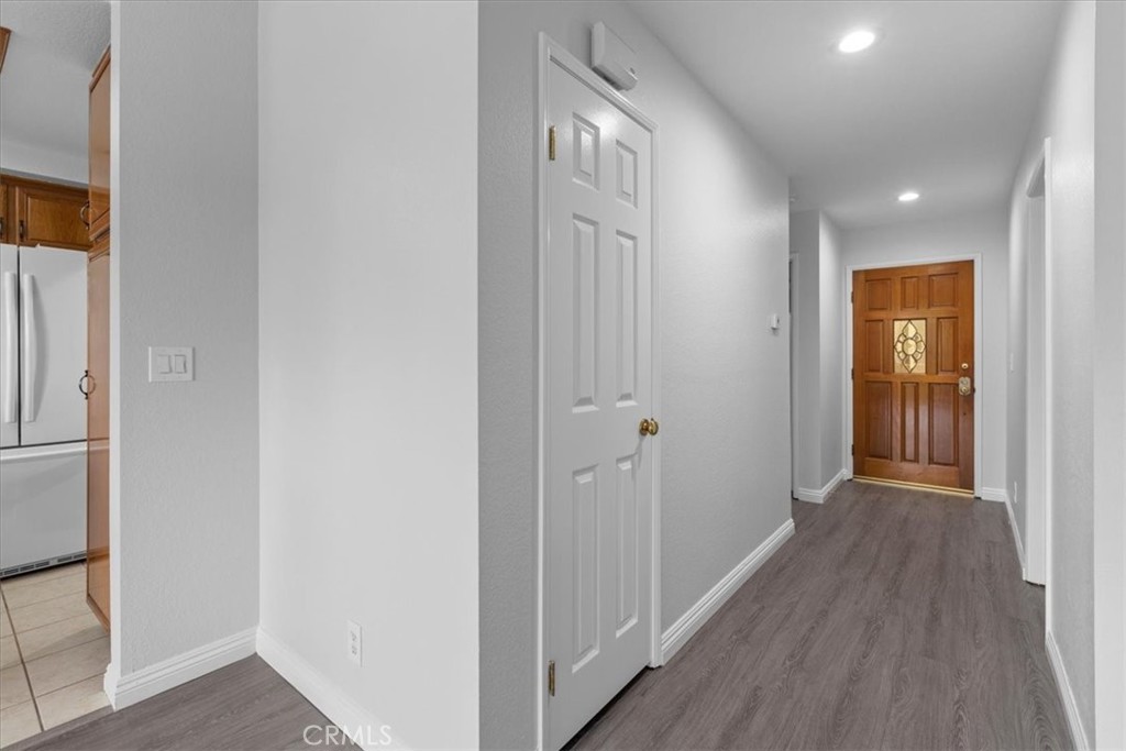 4512 Workman Mill Road, Unit G128 Whittier, CA 90601 - Photo 9 of 26 a view of a hallway with wooden floor