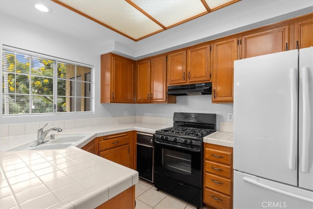 4512 Workman Mill Road, Unit G128 Whittier, CA 90601 - Photo 10 of 26 a kitchen with stainless steel appliances granite countertop a sink stove and refrigerator