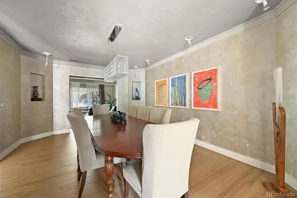 a view of a dining room with furniture and wooden floor