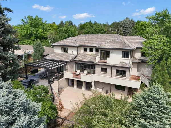 a aerial view of a house with a yard and potted plants