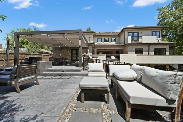a view of a patio with couches table and chairs with wooden floor