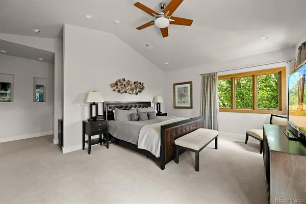 a spacious bedroom with a bed and a table