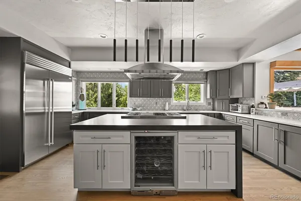 a kitchen with stainless steel appliances granite countertop a sink and cabinets
