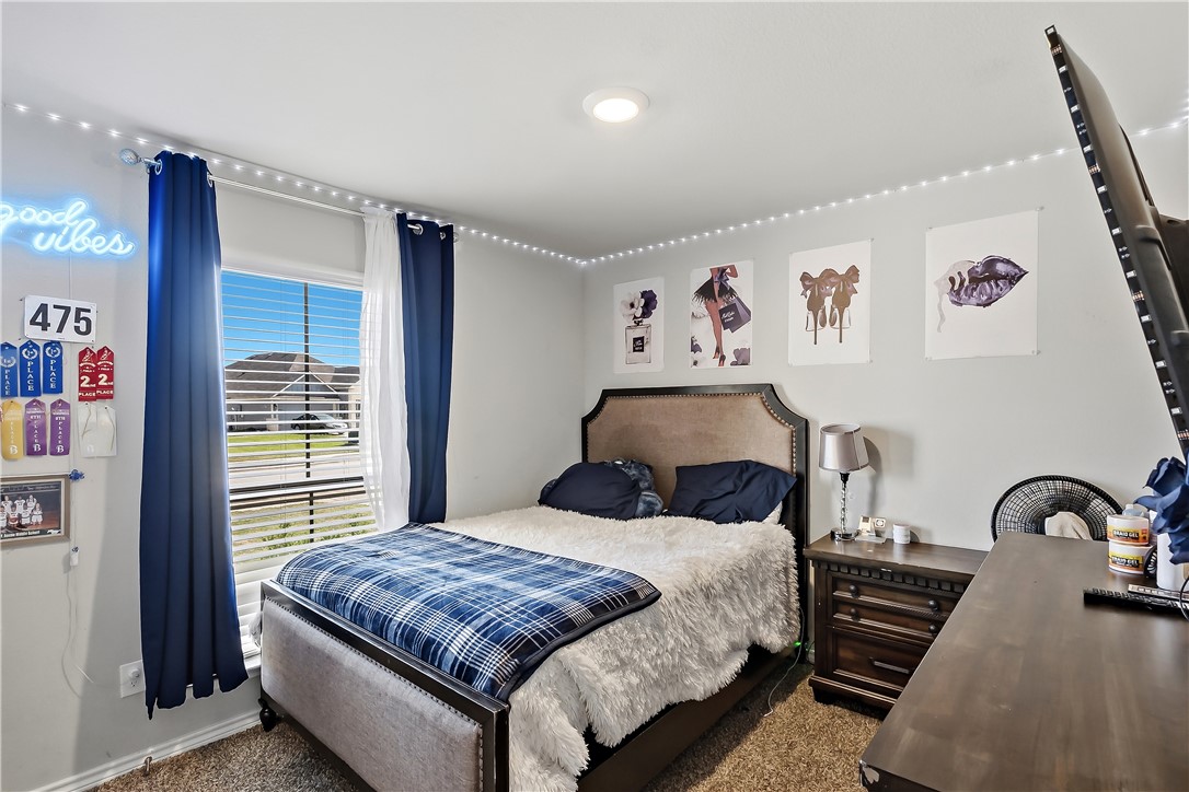 2009 Chief Street Bryan, TX 77807 - Photo 19 of 27 a bedroom with a bed and a large mirror on the dresser