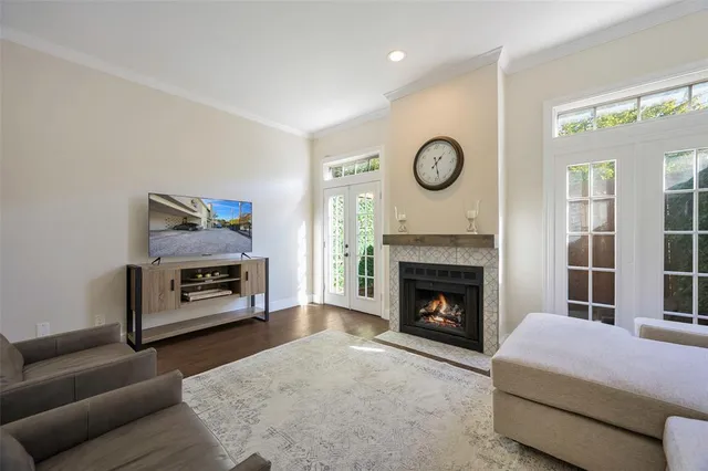 a kitchen with a stove a sink and wooden floor