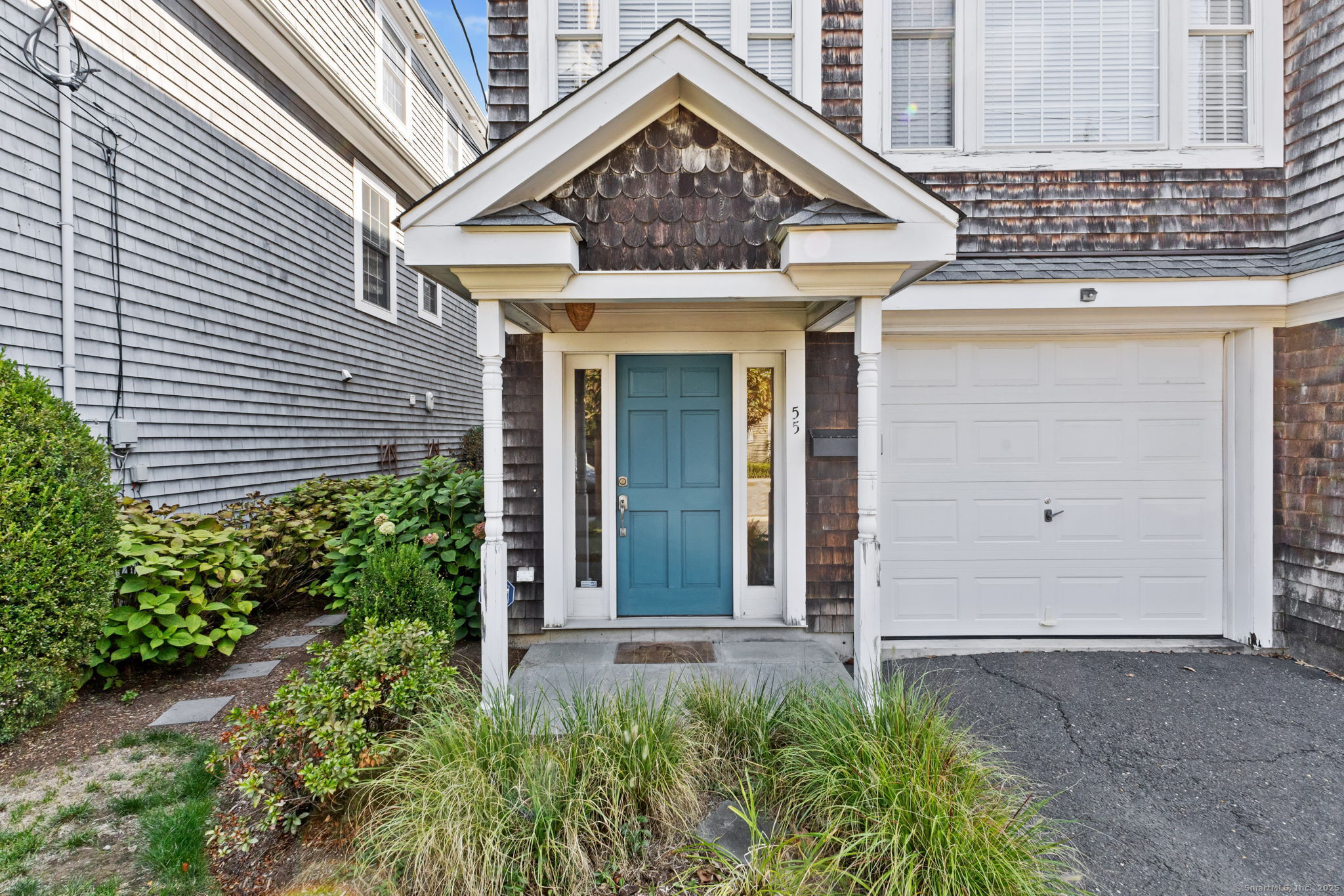 a view of a house with potted plants