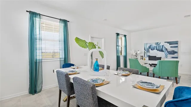 a view of a dining room with furniture and a window