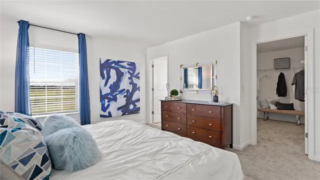 a bedroom with a bed and a dresser