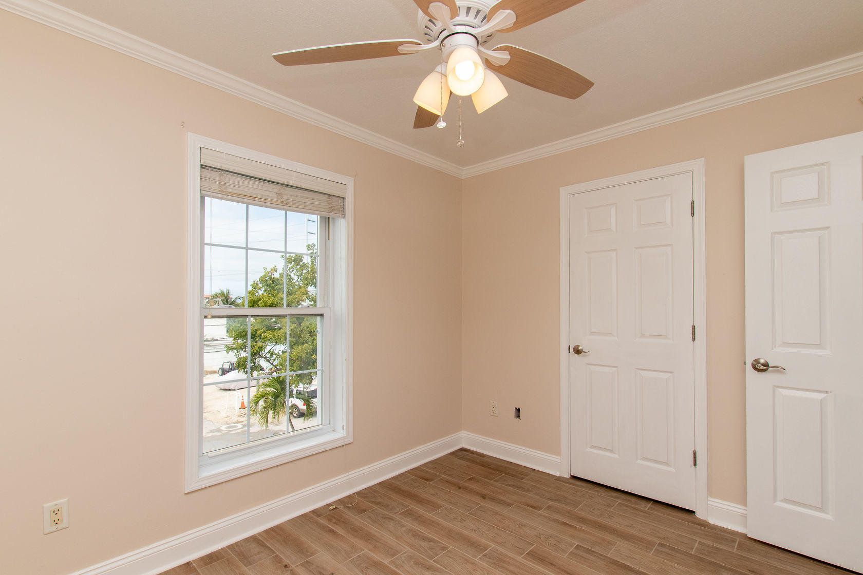 310 24th Marathon, FL 33050 - Photo 27 of 30 an empty room with wooden floor chandelier fan and windows