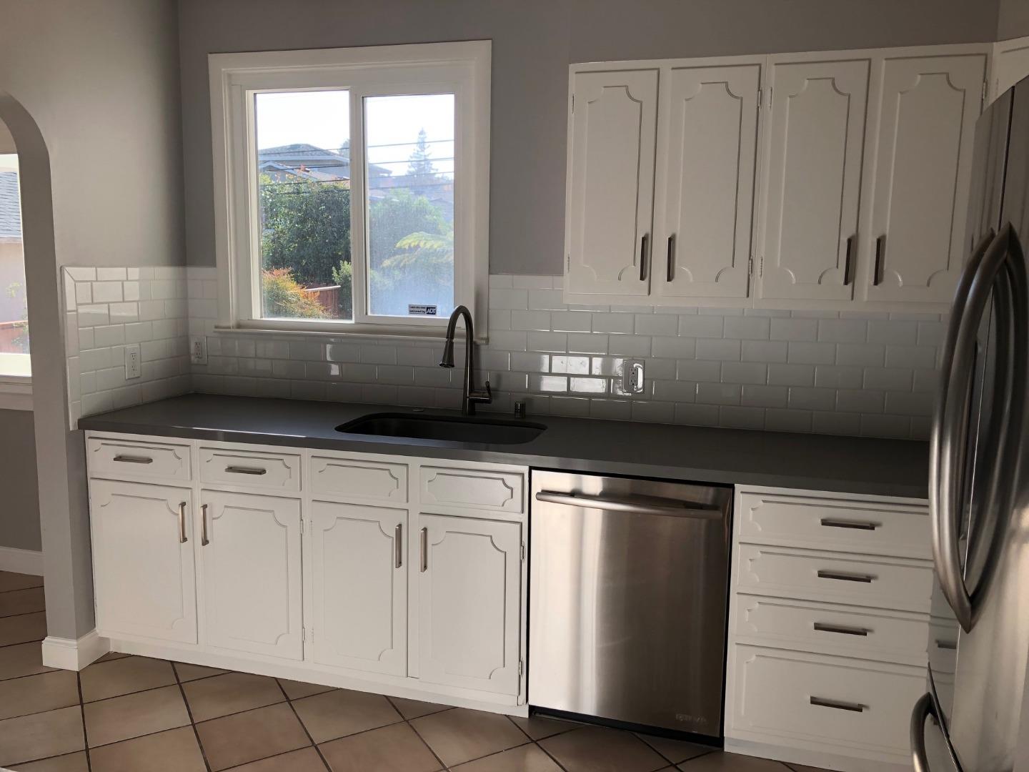 538 Maple Street San Mateo, CA 94402 - Photo 5 of 11 a kitchen with white cabinets and a window