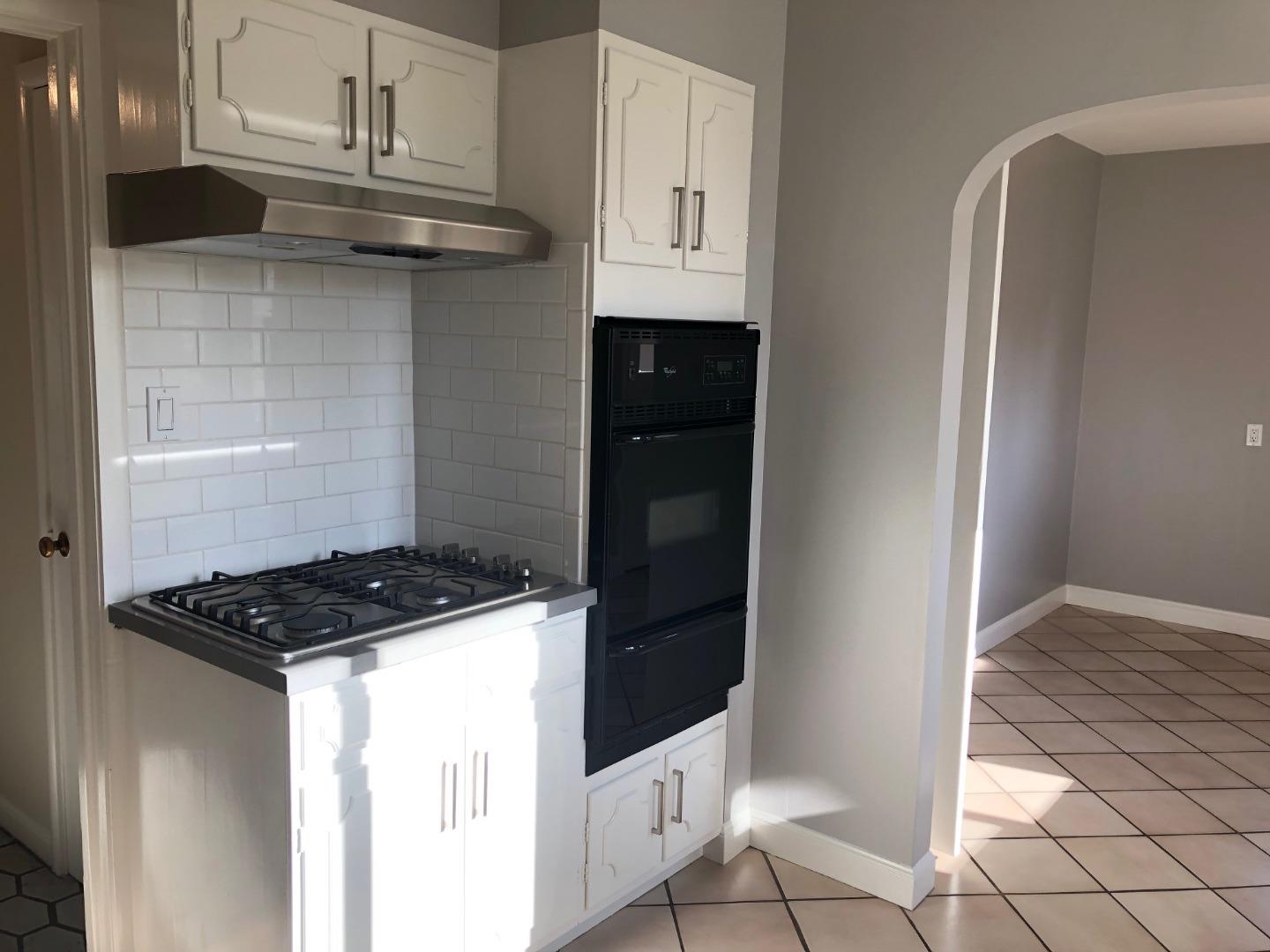 538 Maple Street San Mateo, CA 94402 - Photo 6 of 11 a kitchen with stainless steel appliances granite countertop a stove and a refrigerator