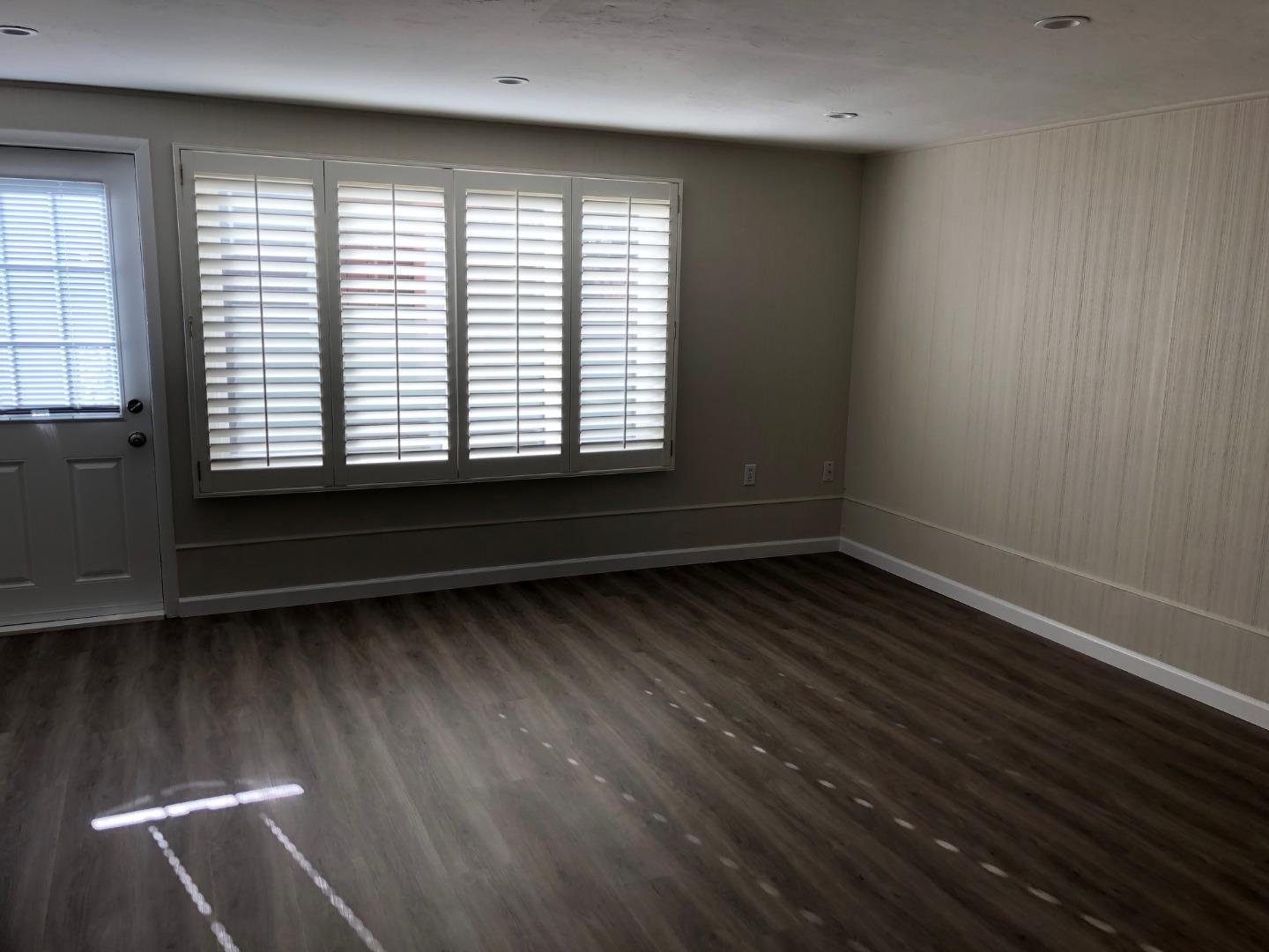 538 Maple Street San Mateo, CA 94402 - Photo 8 of 11 a view of an empty room with wooden floor and a window